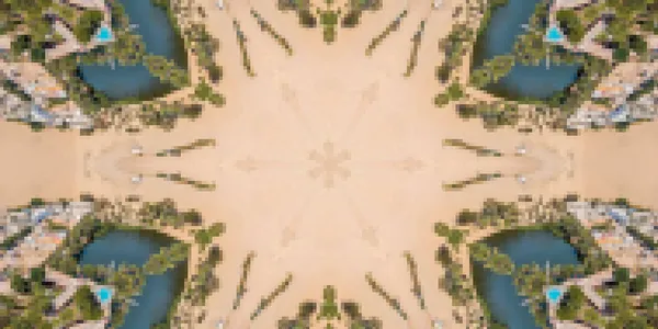 A distorted kaleidoscope view of an aerial landscape with a walkway, lakes and trees