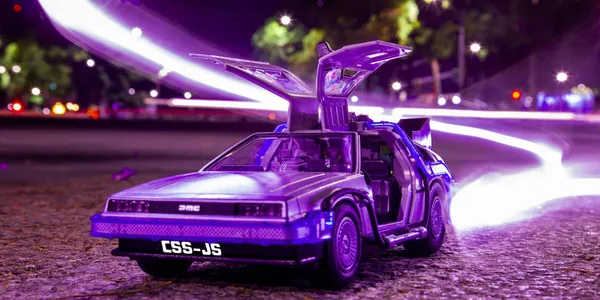 A toy of the deloran car from the movie from Back to The Future has the text: CSS-JS, on its license plate.