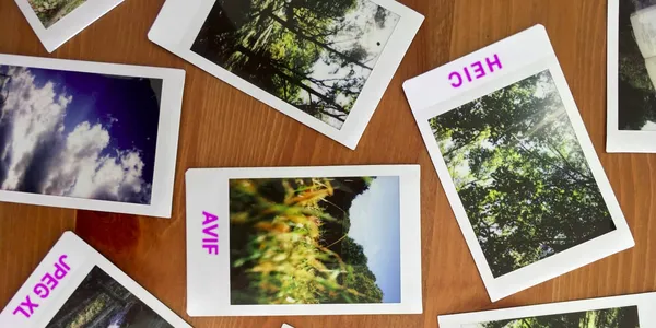 Various polaroid photos ar scattered on a table with some labelled with: heic, avif, and jpegxl.