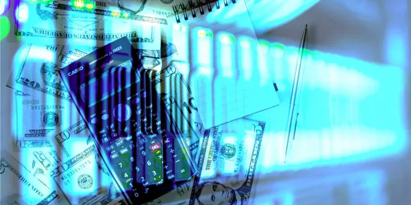 A table top is covered with dollar bills and a calculator. This is a semi-transparent overlay of a rack of glowing servers. Omnious bills boi