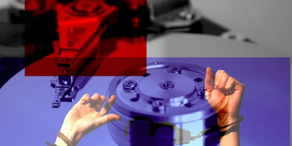 A hard disk and a pair of hands being freed from handcuffs.